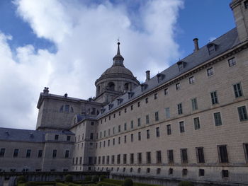 Low angle view of building against cloudy sky