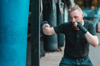 Full length of man standing against wall