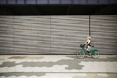 Rear view of man riding bicycle