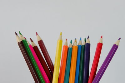 Close-up of colored pencils against white background