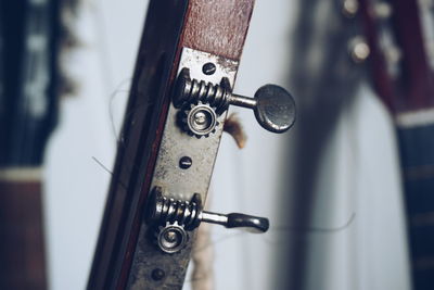 Cropped image of guitar tuning peg