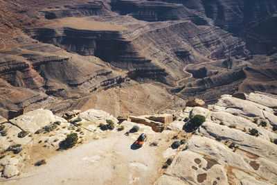 Aerial view of a car on a cliff of a utah canyon