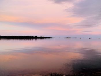 Scenic view of lake against sky at sunset