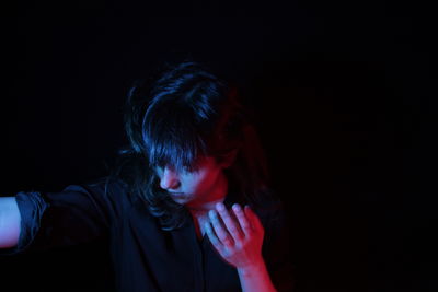 Headshot of woman against black background