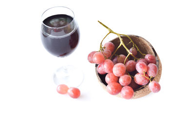 High angle view of berries on table against white background