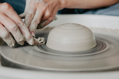 Midsection of woman at pottery workshop