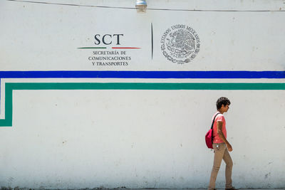 Full length of woman standing on wall