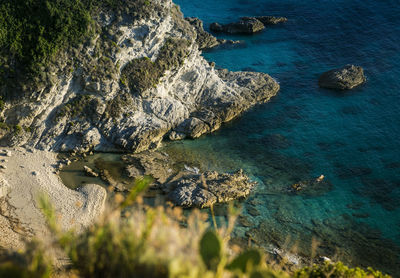 High angle view of rocks on sea