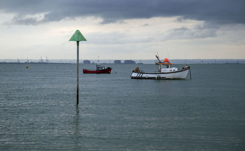 Sailboat in sea against sky