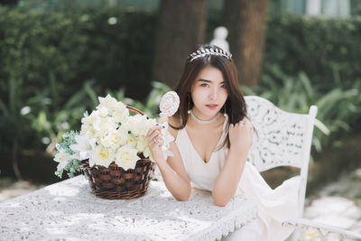 Portrait of a beautiful young woman holding flower