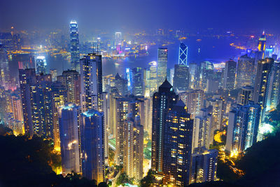 Illuminated cityscape against sky at night