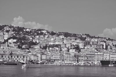 Boats in river with buildings in background