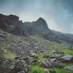 Scenic view of mountains against cloudy sky