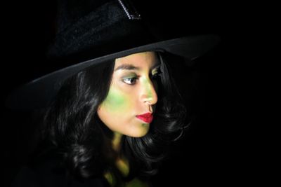 Portrait of beautiful woman against black background