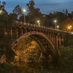 Illuminated bridge at night