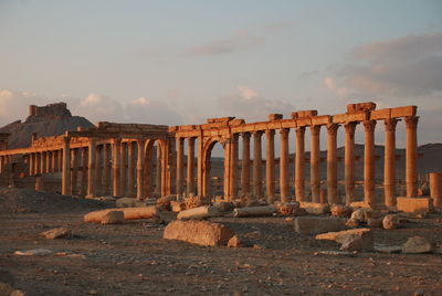 Ancient structure against cloudy sky