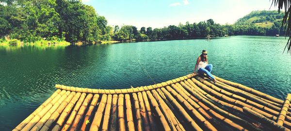 Full length of boy on lake against sky