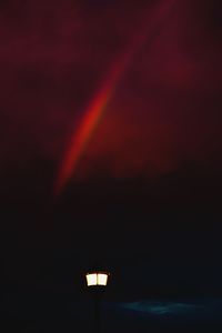 Low angle view of rainbow over street light
