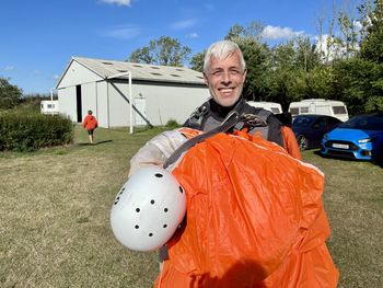 Hsppw skydiver after landing with orange  parachute.