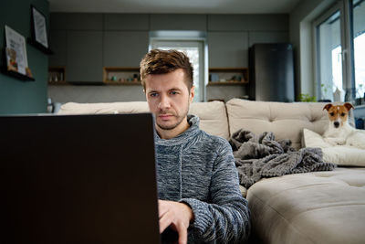 Man using laptop at living room