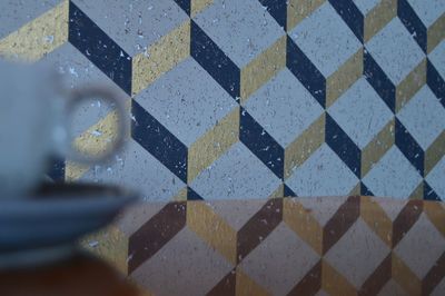 Reflection of patterned wall on table