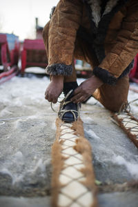 Low section of man wearing ski