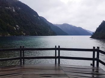 Scenic view of sea and mountains against sky