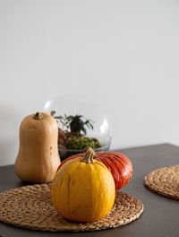 Close-up of pumpkins on table against white background