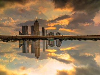 Scenic view of city buildings against sky during sunset