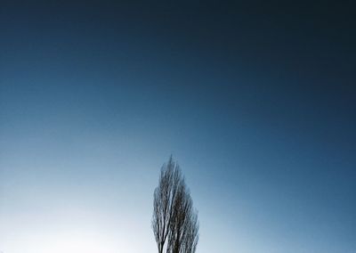 Windmill against clear blue sky