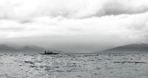 Sailboat sailing on sea against sky