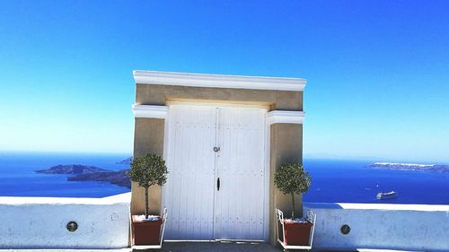 Built structure in sea against blue sky