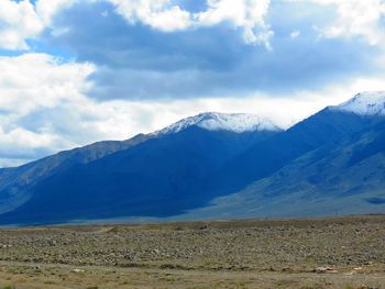 Scenic view of mountains against cloudy sky