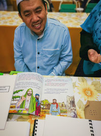 Portrait of a smiling boy on table at restaurant