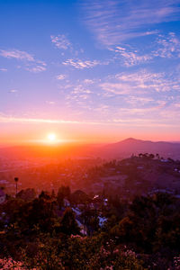 Aerial view of city against sky during sunset