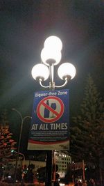 Low angle view of illuminated lamp post at night