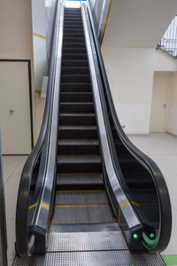 Long black escalator on the move in a public space.