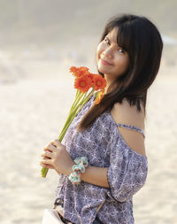 Beautiful woman standing by sea