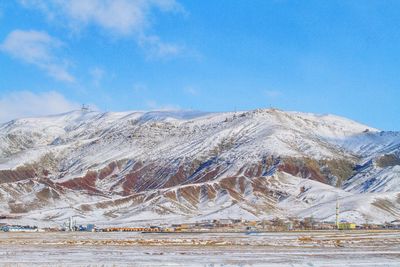 Scenic view of snowcapped mountains against sky