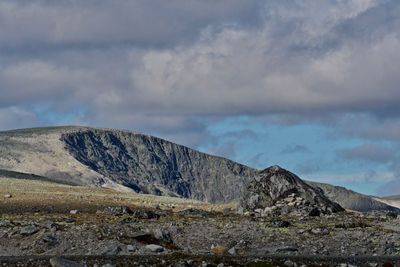 Scenic view of mountain against cloudy sky