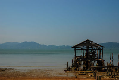 Lifeguard hut on beach against clear sky