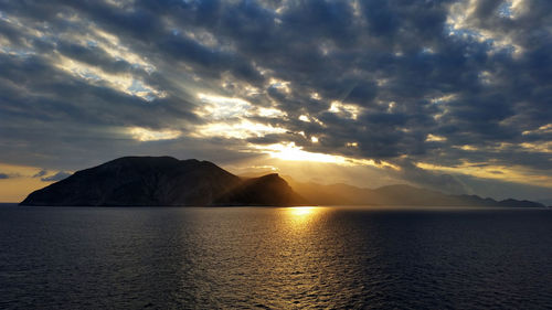 Scenic view of lake against dramatic sky