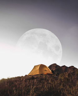 Tent on field against sky at night