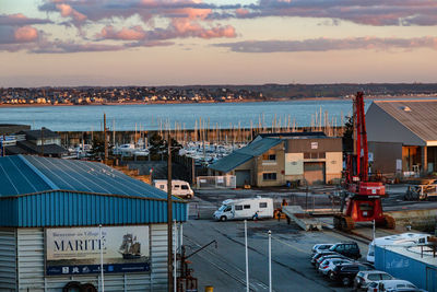 High angle view of city by sea against sky