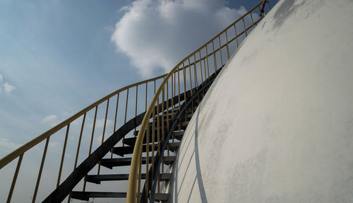 Storage tank at industry against sky