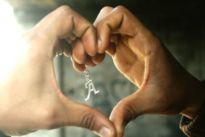 Cropped image of hands making heart shape