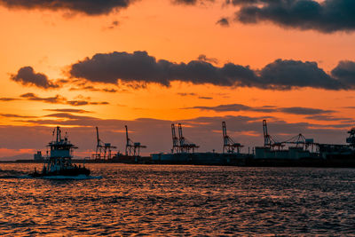 Commercial dock against sky during sunset