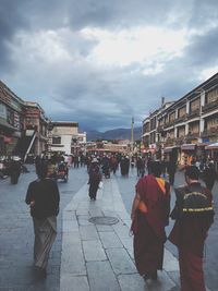 Group of people walking in front of buildings