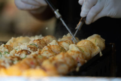Close-up of hand holding meat