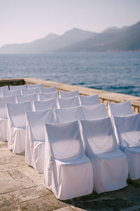 Empty chairs on beach